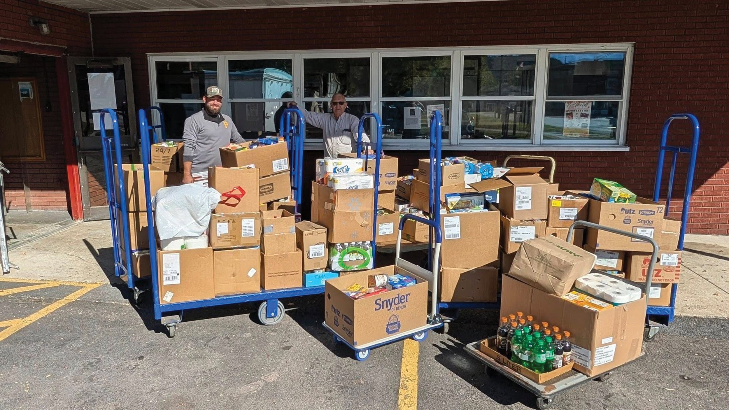 Co-op employee Jarrod Putman, left, and food bank volunteer Charles Younkin fill up carts of donated items